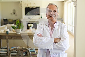 Portrait of senior caucasian male doctor looking at camera and smiling