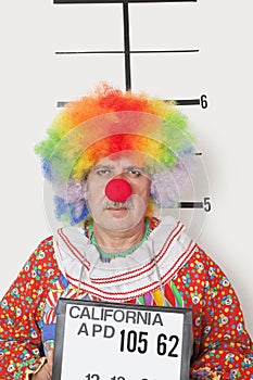 Portrait of senior clown posing for mug shot