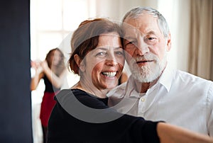 Portrait of senior couple atttending dancing class.