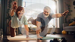 Portrait of a Senior Couple Doing Gymnastics and Yoga Stretching Exercises Together at Home on Sunny