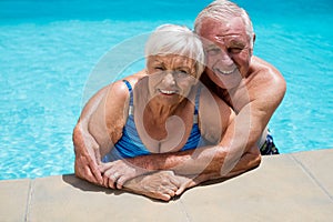 Portrait of senior couple embracing each other in pool