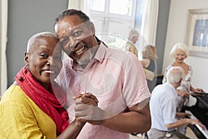 Portrait Of Senior Couple Enjoying Dancing Club Together