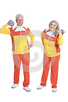 Portrait of senior couple exercising on white background