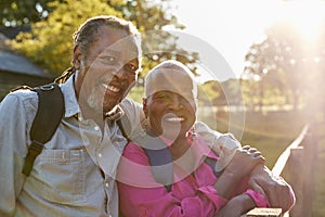 Portrait Of Senior Couple Hiking In Countryside Together