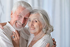 Portrait of senior couple hugging at home