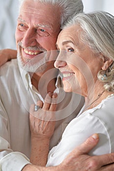 Portrait of senior couple hugging at home