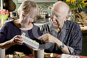 Portrait of Senior Couple with Pill Case