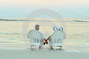 Portrait of senior couple resting on beach