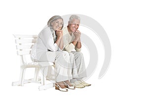 Portrait of senior couple sitting on bench