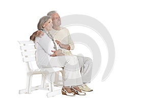 Portrait of senior couple sitting on bench