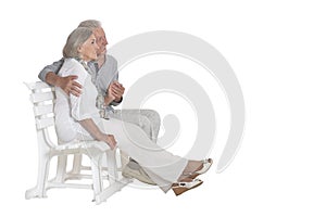 Portrait of  senior couple sitting on bench