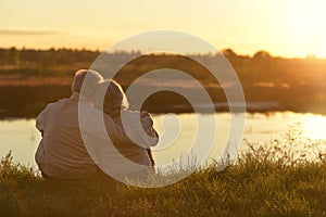 Portrait of senior couple sitting on grass