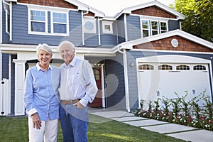 Portrait Of Senior Couple Standing Outside House