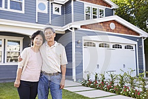 Portrait Of Senior Couple Standing Outside House