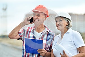 Portrait of senior couple in under construction