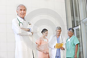 Portrait of senior doctor with staff