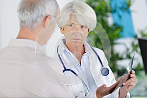 portrait senior doctor talk with elderly patient