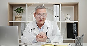 Portrait of senior Doctor Waving Hand to Welcome