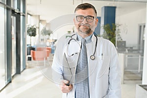 Portrait of senior doctor in white coat