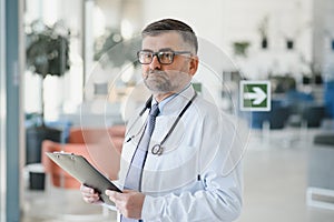 Portrait of senior doctor in white coat