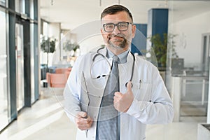 Portrait of senior doctor in white coat