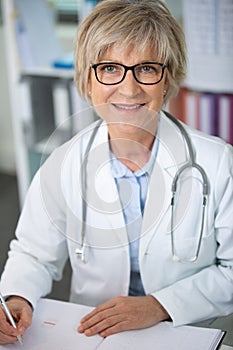 portrait senior doctor at work looking at camera