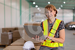 portrait senior engineer supervisor female factory indoor warehouse manager with laptop computer