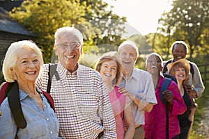 Portrait Of Senior Friends Hiking In Countryside