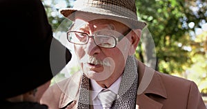 Portrait of senior gentleman smiling when talking with his woman on meet