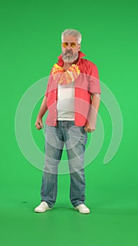 Portrait of senior hipster on Chroma key green screen background, man posing looking at the camera, confident look