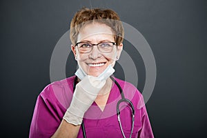 Portrait of senior lady doctor wearing mask and smiling