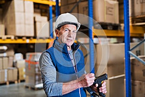 Portrait of a senior male warehouse worker or a supervisor.