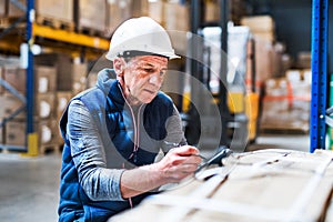 Portrait of a senior male warehouse worker or a supervisor.