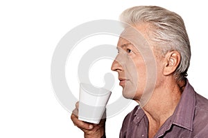 Portrait of senior man drinking cup of coffee