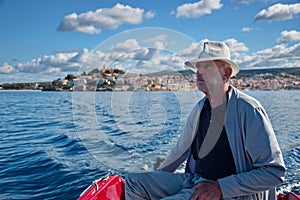 Portrait of senior man driving boat