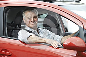 Portrait Of Senior Man Driving Car