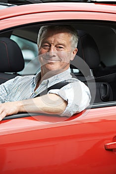 Portrait Of Senior Man Driving Car