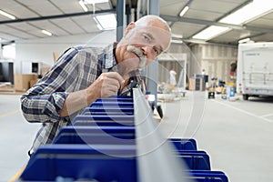 portrait senior man in factory