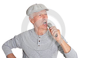 Portrait of senior man in hat singing with microphone
