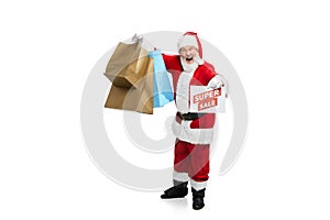 Portrait of senior man in image of Santa Claus with many shopping bags isolated over white background