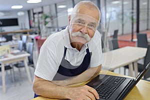 portrait senior man with laptop