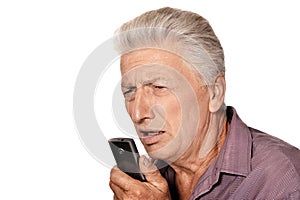 Portrait of senior man with phone on white