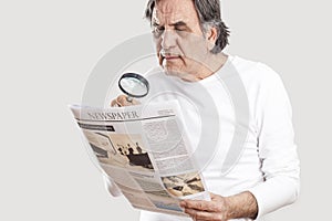 Portrait senior man reading newspaper