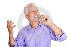 Portrait of senior man singing into microphone