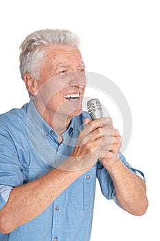 Portrait of senior man in singing with microphone