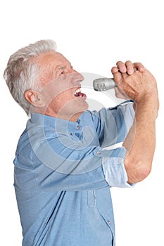 Portrait of senior man in singing with microphone