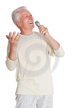 Portrait of senior man singing into microphone