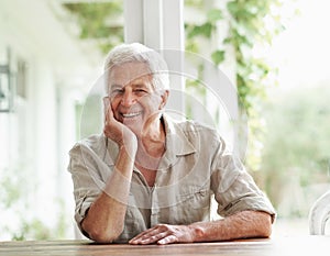 Portrait of senior man, smile and relax in home for retirement and good mood. Face of happy elderly male person on house