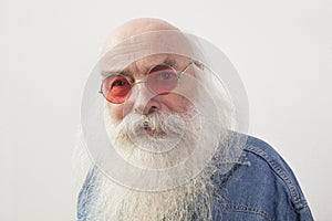 Portrait of senior man wearing red glasses over gray background