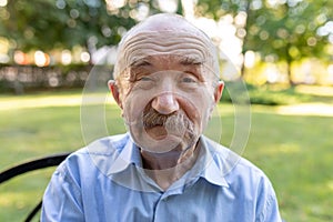 Portrait of senior man with white mustache looking at camera and making faces. Man looking goofy and funny with a silly cross-eyed